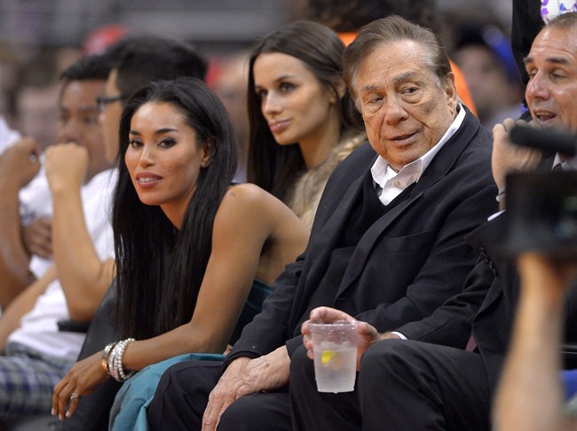 Los Angeles Clippers owner Donald Sterling, right, watches the Clippers courtside in Los Angeles on Oct. 25, 2013.