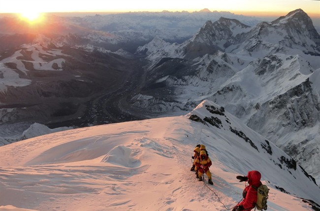 In this May 18, 2013 file photo released by mountain guide Adrian Ballinger of Alpenglow Expeditions, climbers make their way to the summit of Mount Everest, in the Khumbu region of the Nepal Himalayas.