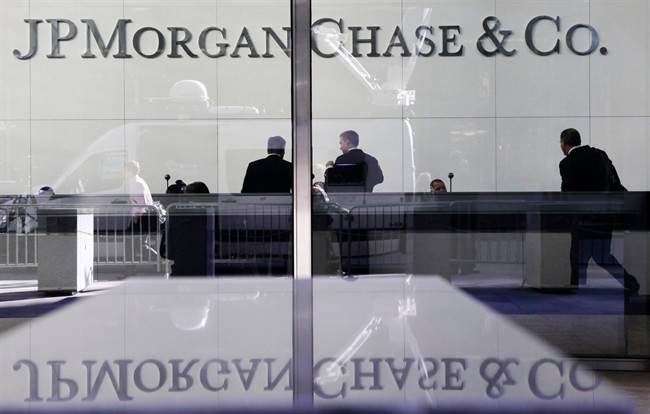 People stand in the lobby of JPMorgan Chase headquarters in New York. JPMorgan, one of the nation’s biggest banks and the largest U.S. investment bank.