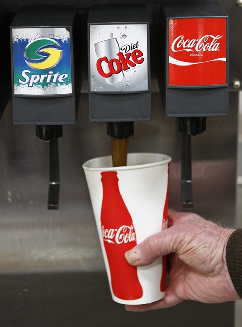 FILE - In this March 3, 2010 file photo, a Costco customer pours a Diet Coke drink at Costco in Mountain View, Calif. The fixation on calorie counts that defined dieting for so long is giving way to other considerations, like the promise of more fiber or natural ingredients. The shift is chipping away at the popularity of products like Diet Coke, Lean Cuisine, Special K and Yoplait Light, which became dieting staples primarily by virtue of being calorie-stripped alternatives to people’s favorite foods. (AP Photo/Paul Sakuma, file)