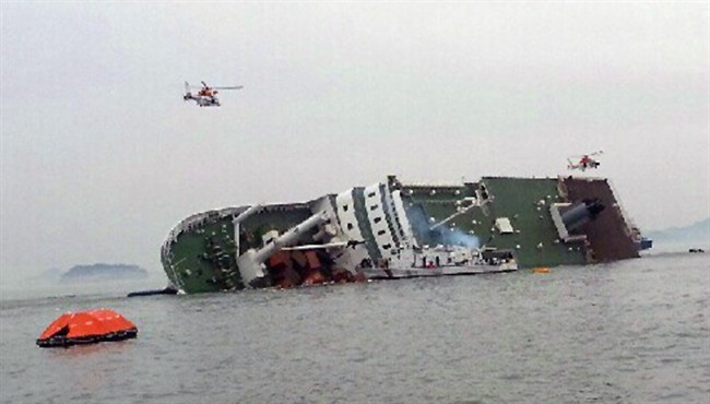 South Korean rescue helicopters fly over a South Korean passenger ship, trying to rescue passengers from the ship in water off the southern coast in South Korea, Wednesday, April 16, 2014.