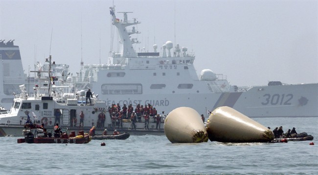 Relatives, center, of passengers aboard the sunken Sewol ferry visit the site where the ship sank to observe the search operation in the water off the southern coast near Jindo, South Korea, Thursday, April 24, 2014. 