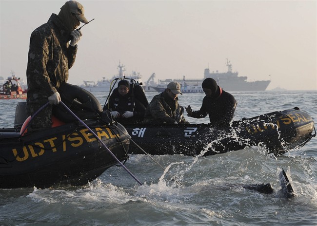 Divers look for people believed to have been trapped in the sunken ferry off the coast of South Korea.
