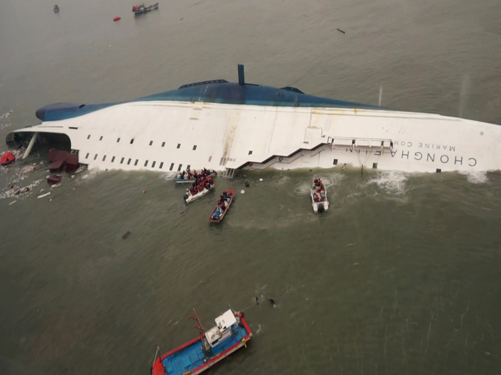 In this photo released by South Korea Coast Guard via Yonhap News Agency, South Korean rescue team boats and fishing boats try to rescue passengers.
