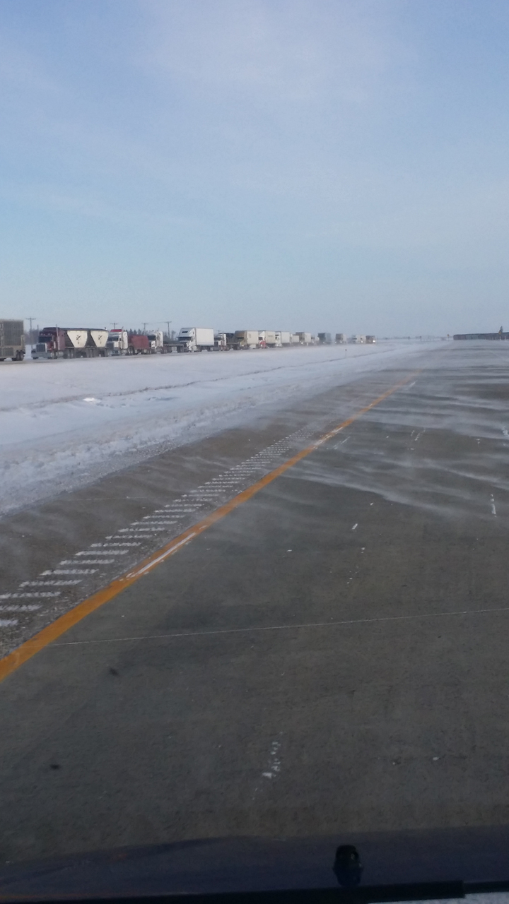 Trucks line up along U.S. Interstate 29 as it reopens on Tuesday morning.