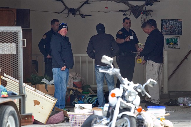 Authorities investigate a crime scene at a house in Pleasant Grove, Utah, Sunday, April 13, 2014.