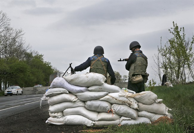 Ukrainian government troops guard a checkpoint near the village of Dolina, 30 kilometers (18 miles) from Slovyansk, eastern Ukraine, Tuesday, April 29, 2014. 