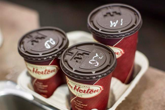 Coffee cups sit at a Tim Hortons in Oakville, Ont. on September 16, 2013.