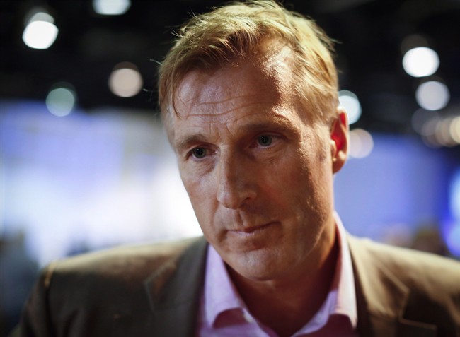 Maxime Bernier, Minister of State for Small Business and Tourism, speaks to reporters at the Conservative convention in Calgary, Saturday, Nov. 2, 2013.