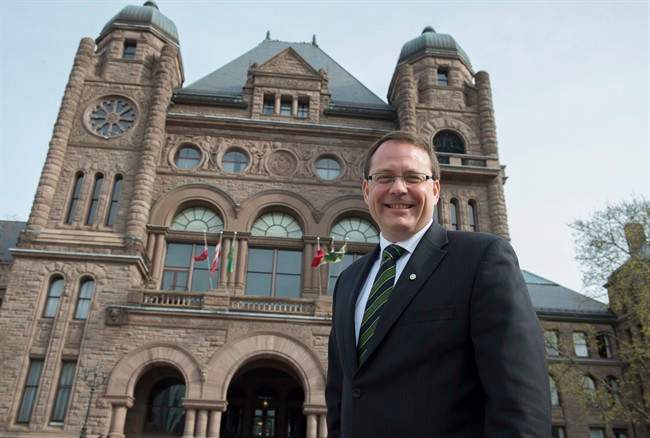 Green Party Leader Mike Schreiner poses for a photo in front of the Ontario Legislature in Toronto on Wednesday, May 7, 2014.