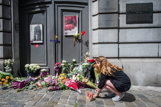 A girl lights candles at the Jewish Museum in Brussels, Sunday, May 25, 2014. 