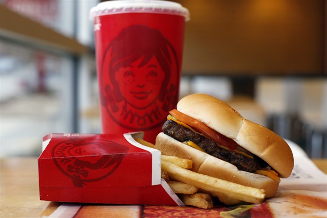 This March 17, 2014 photo shows a Wendy's single hamburger with cheese combo meal at a Wendy's restaurant in Pittsburgh.