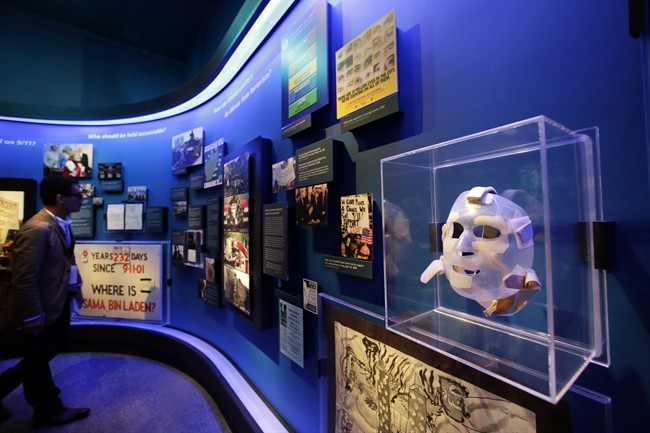 The burn mask, right, of a World Trade Center survivor who was injured by burning jet fuel, is displayed at the National Sept. 11 Memorial Museum, Wednesday, May 14, 2014, in New York.
