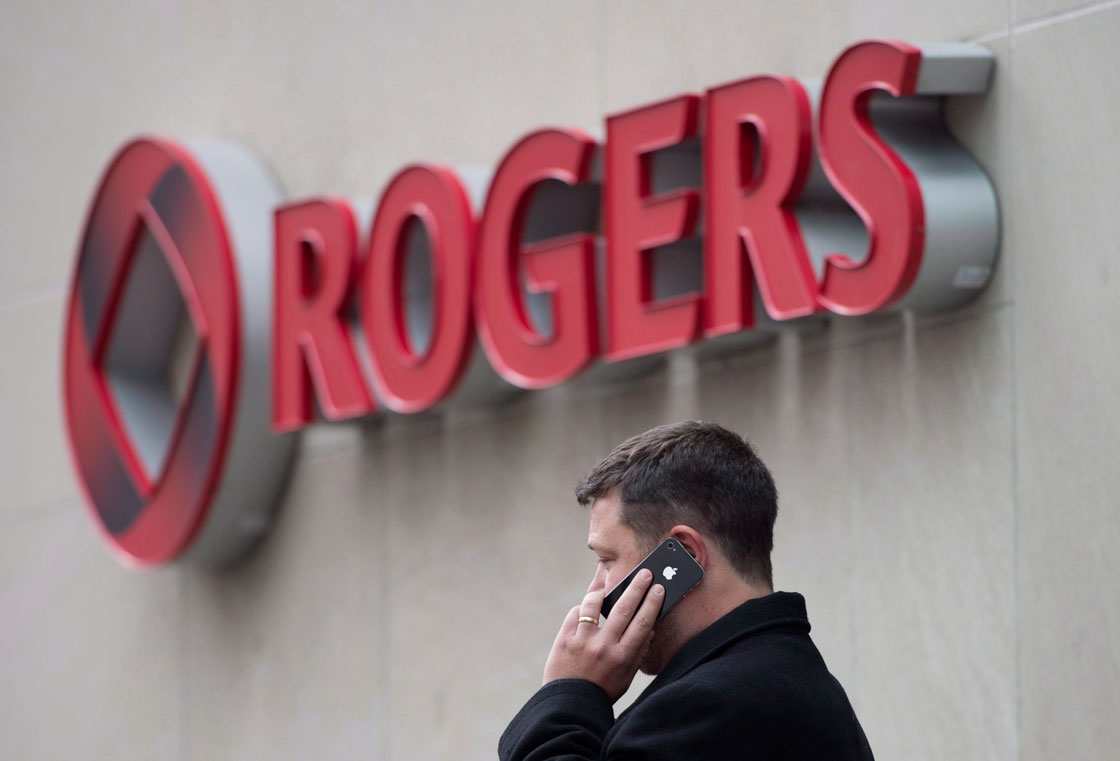 A man speaks on a mobile phone outside Rogers Communications Inc.'s annual general meeting of shareholders in Toronto on Tuesday, April 22, 2014