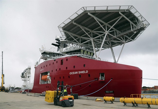 In this March 30, 2014 file photo, Australian Defense ship Ocean Shield is docked at naval base HMAS Stirling while being fitted with an autonomous underwater vehicle (AUV) and towed pinger locator to aid in the search for missing Malaysia Airlines Flight MH370, in Perth, Australia.  (AP Photo/Rob Griffith, File).