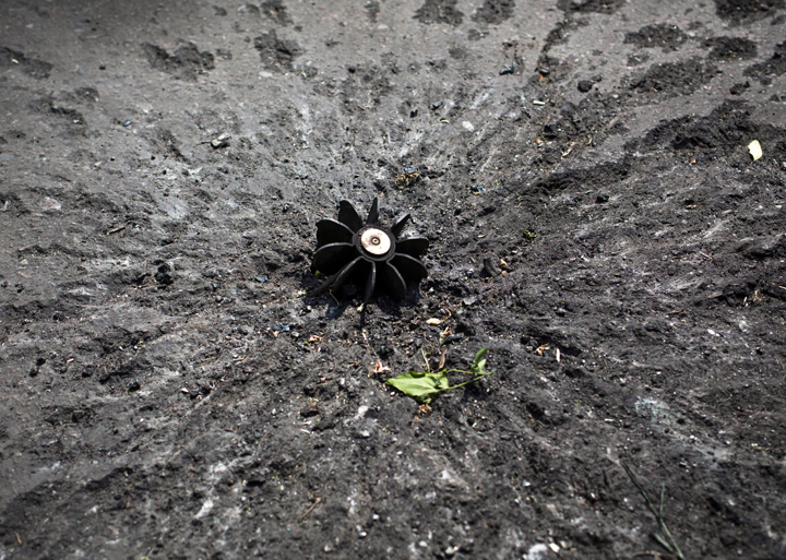 A part of the mortar shell seen at a checkpoint near Slovyansk, eastern Ukraine, Thursday, May 15, 2014. The Organization for Security and Cooperation in Europe, a trans-Atlantic security group, put forward a "road map" calling for national dialogue as a first step toward resolving the escalating tensions. 