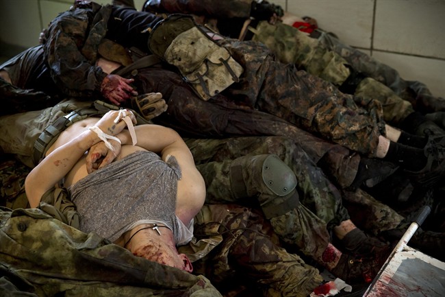 The bodies of pro-Russian gunmen killed in clashes with Ukrainian government forces around the airport are piled up at a city morgue in Donetsk, Ukraine, Tuesday, May 27, 2014. 