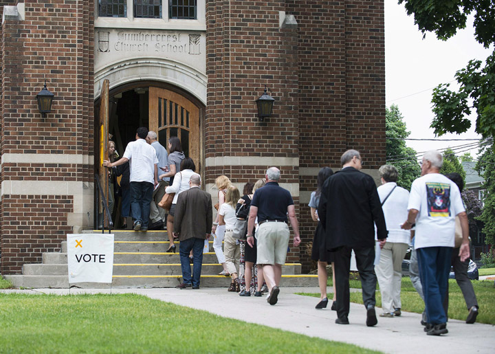 Voters flock to a poll in Toronto's west end, June 12, 2014.