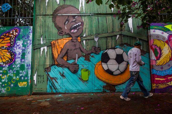 SAO PAULO, BRAZIL - MAY 24: Graffiti on a wall of a public school criticizes the hosting of the World Cup on May 24, 2014 in Sao Paulo, Brazil. Members of Anarchist Black Bloc protested against President Dilma Rousseff and corruption in the country. Demonstrators chanted ''will not get Cup!'' during the protests and later burned the Brazilian flag along with the official sticker album of the World Cup.
