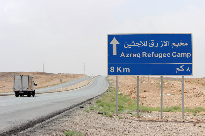 A road sign on the highway pointing to Azraq Refugee Camp