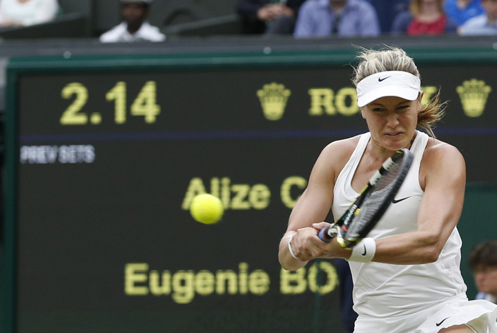 Eugenie Bouchard plays a return to Alize Cornet of France during their women's singles match at the All England Lawn Tennis Championships in Wimbledon, London, Monday, June 30, 2014. 