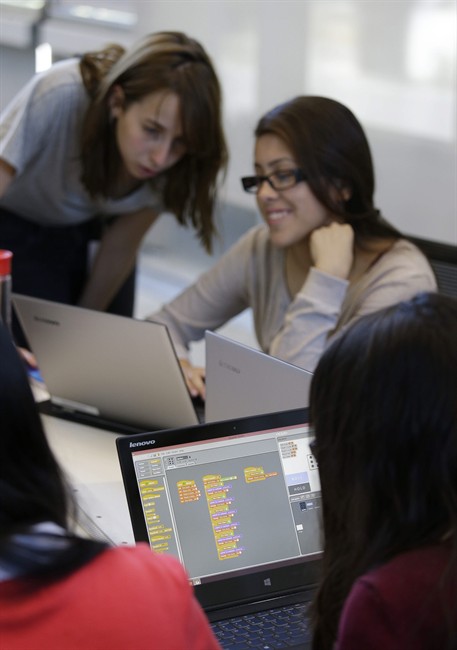 File photo of an educational assistant helping a student. 