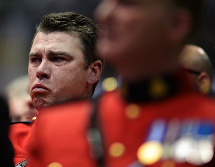 An RCMP officer tries to contain his emotions at the RCMP regimental funeral on Tuesday, June 10, 2014 for the three RCMP officers who were gunned down in Moncton last week.