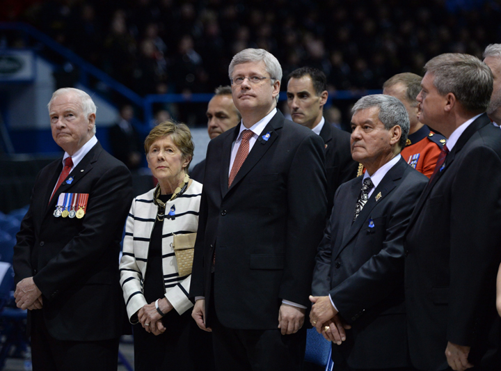 Governor General David Johnston (left to right) and wife Sharon, Prime Minister Stephen Harper, N.B. Lt. Gov. Graydon Nicholas and N.B. Premier David Alward wait for the start of the RCMP regimental funeral on Tuesday, June 10, 2014 for the three RCMP officers who were gunned down in Moncton last week.
