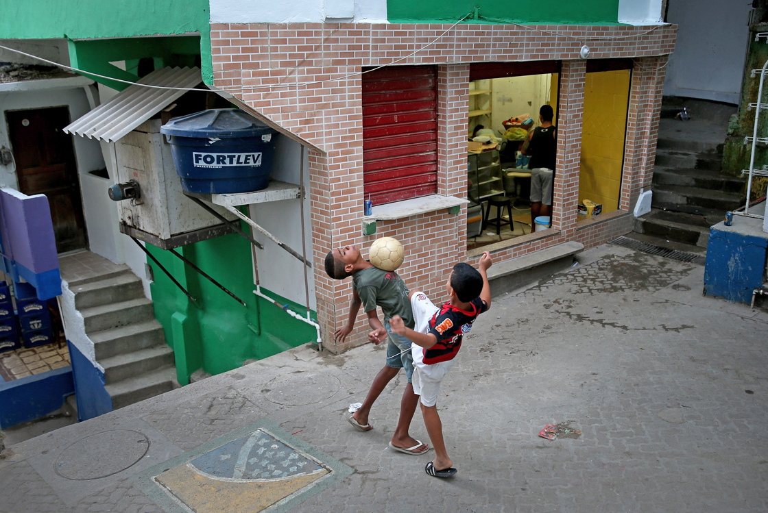 RIO DE JANEIRO, BRAZIL - JUNE 08: Children play a game of soccer in the streets of a 'favela' called Santa Marta on June 8, 2014 in Rio de Janeiro, Brazil. Brazil continues to prepare to host the World Cup which starts on June 12th and runs through July 13th. (Photo by Joe Raedle/Getty Images)