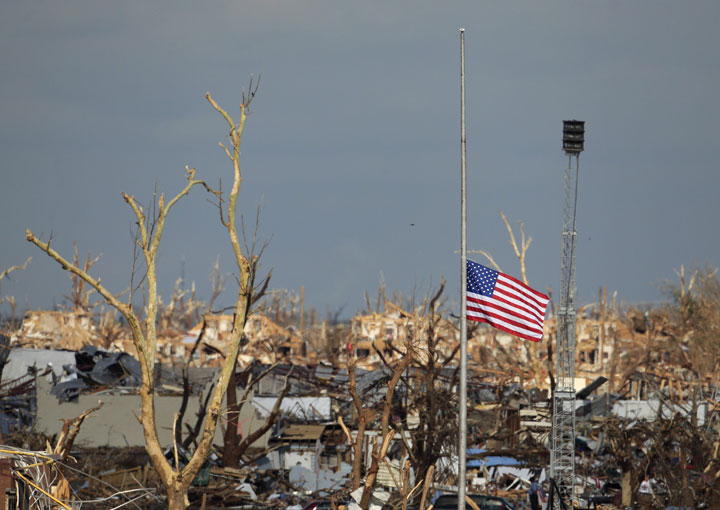A portable tornado siren sits among the ruins of Joplin, Mo. staff after a deadly tornado struck in 2011.