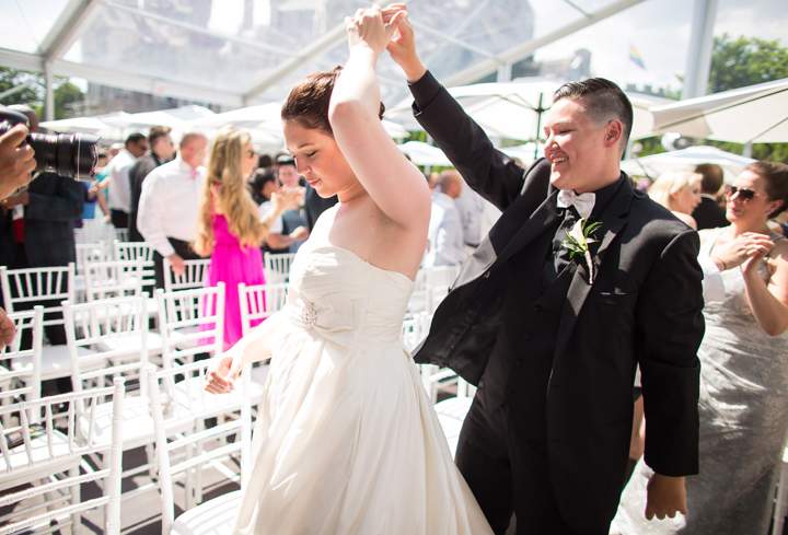 Dana Murphy (L) and Shannon St Germain dance during the Grand Pride Wedding, a mass gay wedding at Casa Loma in Toronto, Canada, on June 26, 2014.