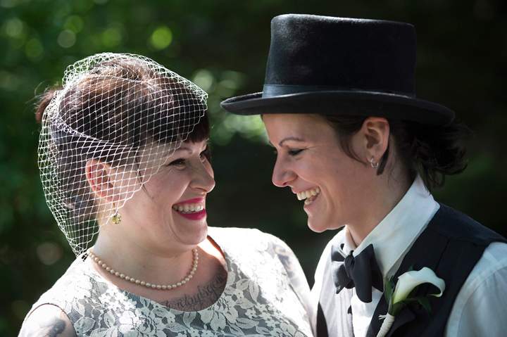 Michelle, left, and May Brand laugh before joining over 100 gay couples in a mass wedding during World Pride 2014 at Casa Loma in Toronto, on Thursday, June 26, 2014.