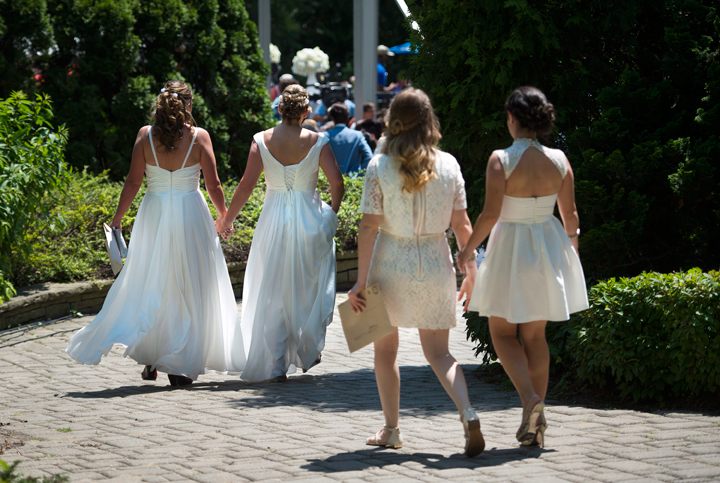 Couples walk hand-in-hand before joining over 100 other gay couples in a mass wedding during World Pride 2014 at Casa Loma in Toronto, on Thursday, June 26, 2014.