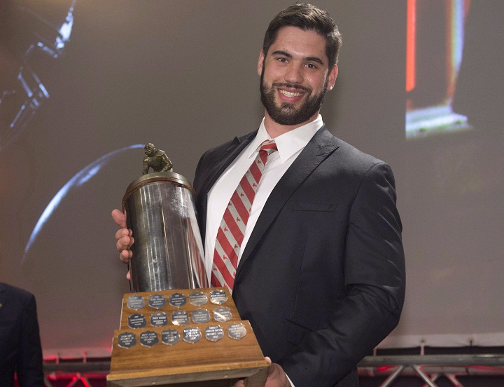 Laurent Duvernay-Tardif, of the McGill University Redmen, receives the J.P. Metras Trophy as the Outstanding Down Lineman during Vanier Cup celebrations Thursday, November 21, 2013 in Quebec City.