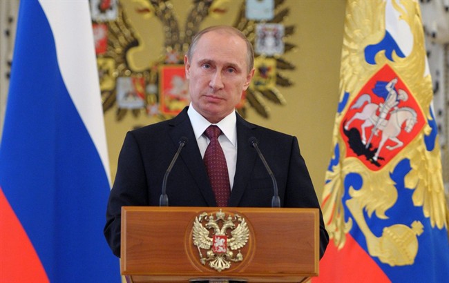 FILE - In this June 26, 2014, file photo, Russian President Vladimir Putin addresses graduates of military academies in Moscow's Kremlin.