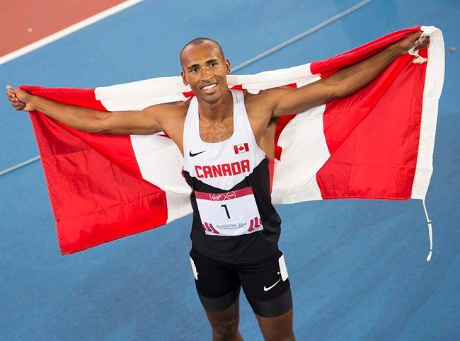 Canada's Damian Warner displays the flag after winning the gold medal in decathlon at Hampden Park at the Commonwealth Games in Glasgow, Scotland on Tuesday, July 29, 2014.
