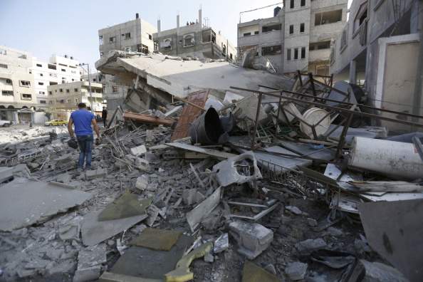 A Palestinian man walks though Mohammed al-Ghul's house after it was targeted in an Israeli airstrike in Gaza City on August 25, 2014. One of Sunday's air strikes killed Hamas financial official Mohammed al-Ghul as he was travelling by car in Gaza City. An Israeli air raid in Gaza left two Palestinians dead overnight, taking the number of killed Palestinians in the seven-week conflict to 2,122, Palestinian sources said. 