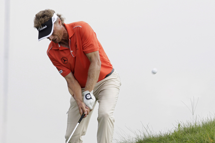Bernhard Langer, of Germany, chips out of the deep rough at the edge of the 18th green during the third round of the Champions Tour 3M Championship golf tournament at TPC Twin Cities in Blaine, Minn., Sunday, Aug. 3, 2014.