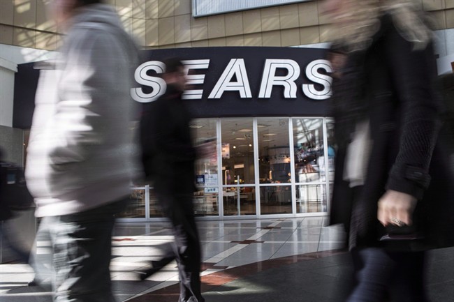 Commuters walk past a Sears store in Toronto.