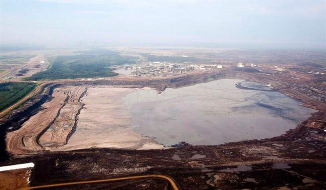 A tailings pond at the Syncrude oilsands facility is seen from a helicopter near Fort McMurray, Alta., July 10, 2012.
