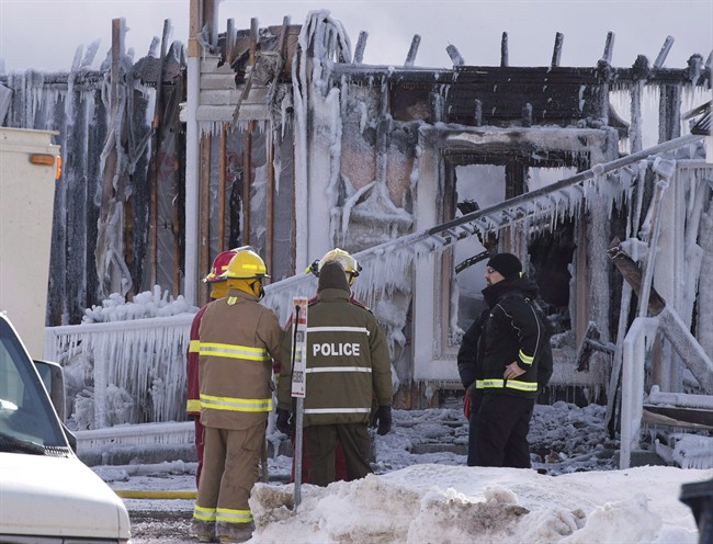 Firefighters work at the scene of a fatal fire at a seniors residence in L'Isle-Verte, Que., Thursday, January 23, 2014.