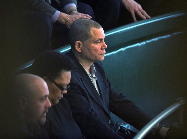 Tony Smith, right, a former resident of the Nova Scotia Home for Colored Children, listens to the throne speech in the legislature in Halifax on Tuesday. March 26, 2013. 