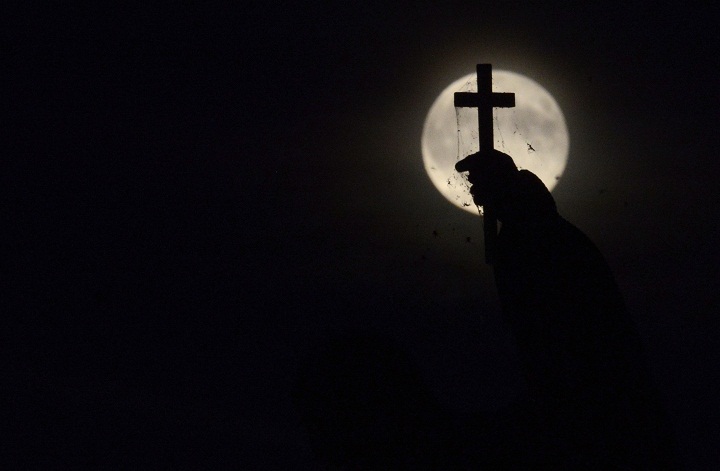 The full moon nicknamed "the supermoon" rises over the statue on the Charles Bridge on August 10, 2014 in Prague.