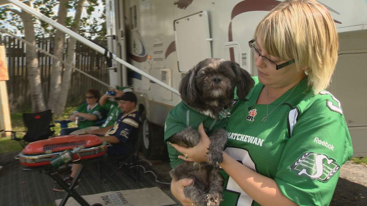 Brittany Gent holds up her dog Rider at Kings Acres Campground on Sunday.