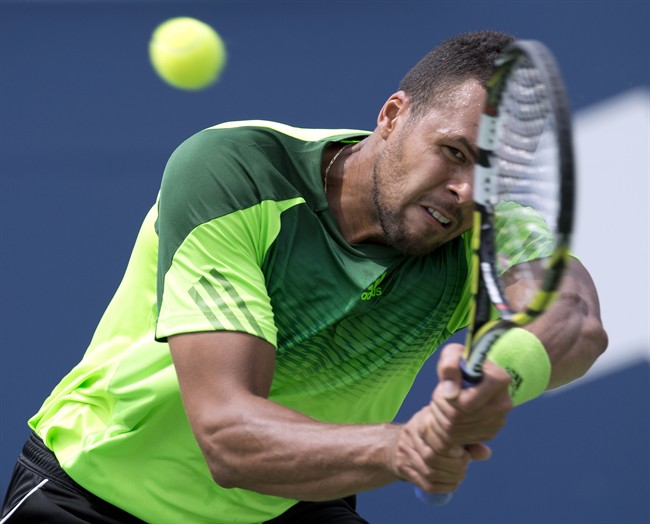 Jo-Wilfried Tsonga of France hits a backhand during win over Andy Murray of Great Britain in Rogers Cup tennis quarter-final action in Toronto on Friday August 8, 2014. THE CANADIAN PRESS/Frank Gunn.
