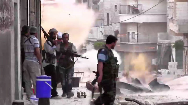 An image grab taken from AFP TV shows Syrian rebels taking position during clashes with Syrian regime forces in the Amariyeh district of the northern city of Aleppo on August 31, 2012.