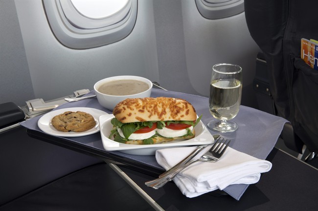 This product image provided by United Airlines shows a Caprese on Asiago Baguette sandwich, one of a variety of the airline’s new first class food options.