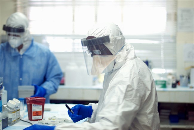 This undated handout photo provided by the journal Science shows Augustine Goba, laboratory director at Kenema Government Hospital in Sierra Leone. 