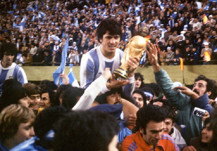 Argentine’s national soccer team captain Daniel Passarella holds the World Cup trophy as he is carried on the shoulders of fans after Argentina defeated the Netherlands 3-1 in extra time, 25 June 1978 in Buenos Aires, during the World Cup soccer final.