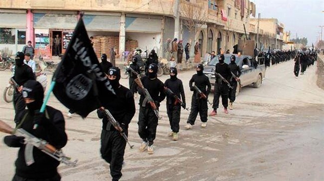 This file image posted on a militant website on Tuesday, Jan. 14, 2014, shows fighters from the al-Qaida linked so-called Islamic State, marching in Raqqa, Syria. Canadians who abandoned this nation for IS and similar organizations are officially dubbed "terrorist travellers" and some 200 have reportedly returned to face absolutely no legal consequences.
